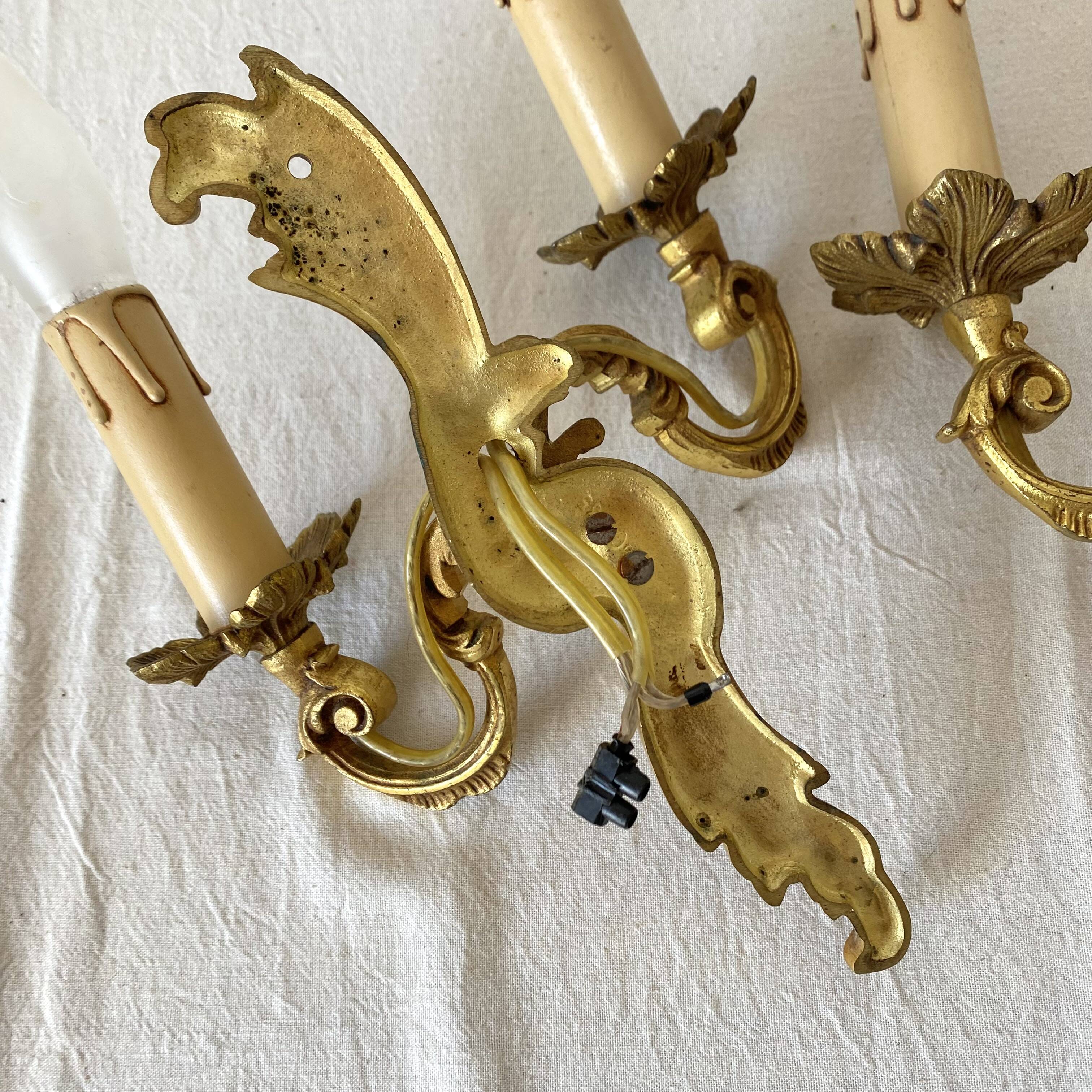 Pair of golden rococo-style wall lights