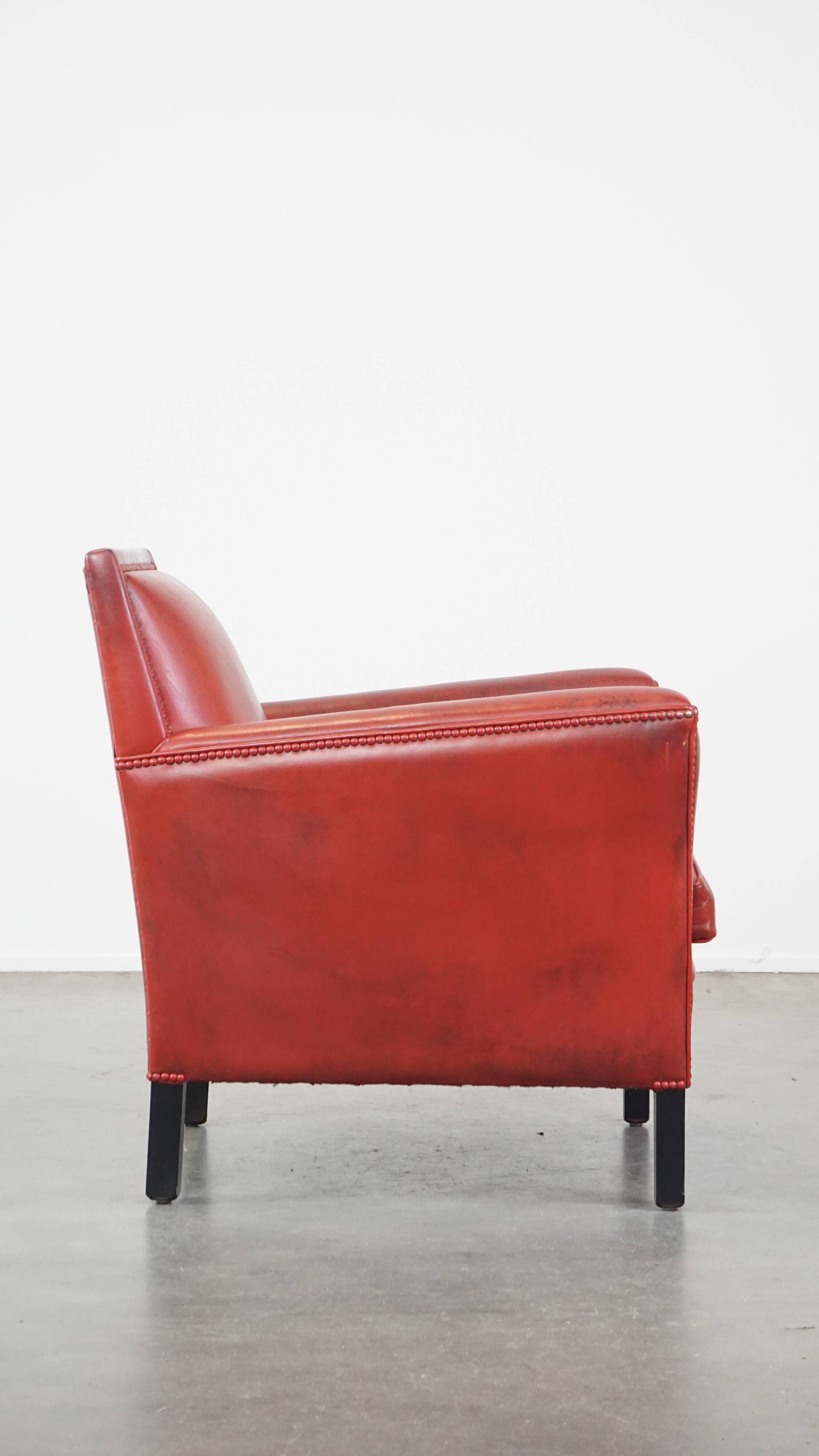 Red-painted armchair made of sheepskin leather