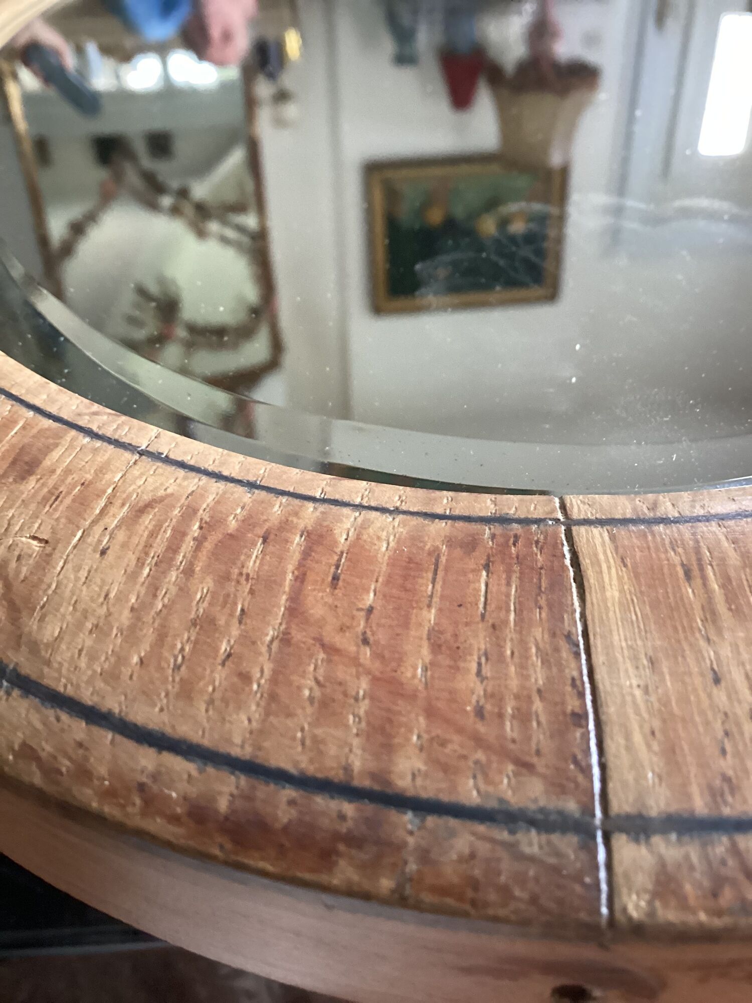Oval beveled mirror surrounded by light wood dimension: height -74,5cm- width -38,5cm- prof-2cm-