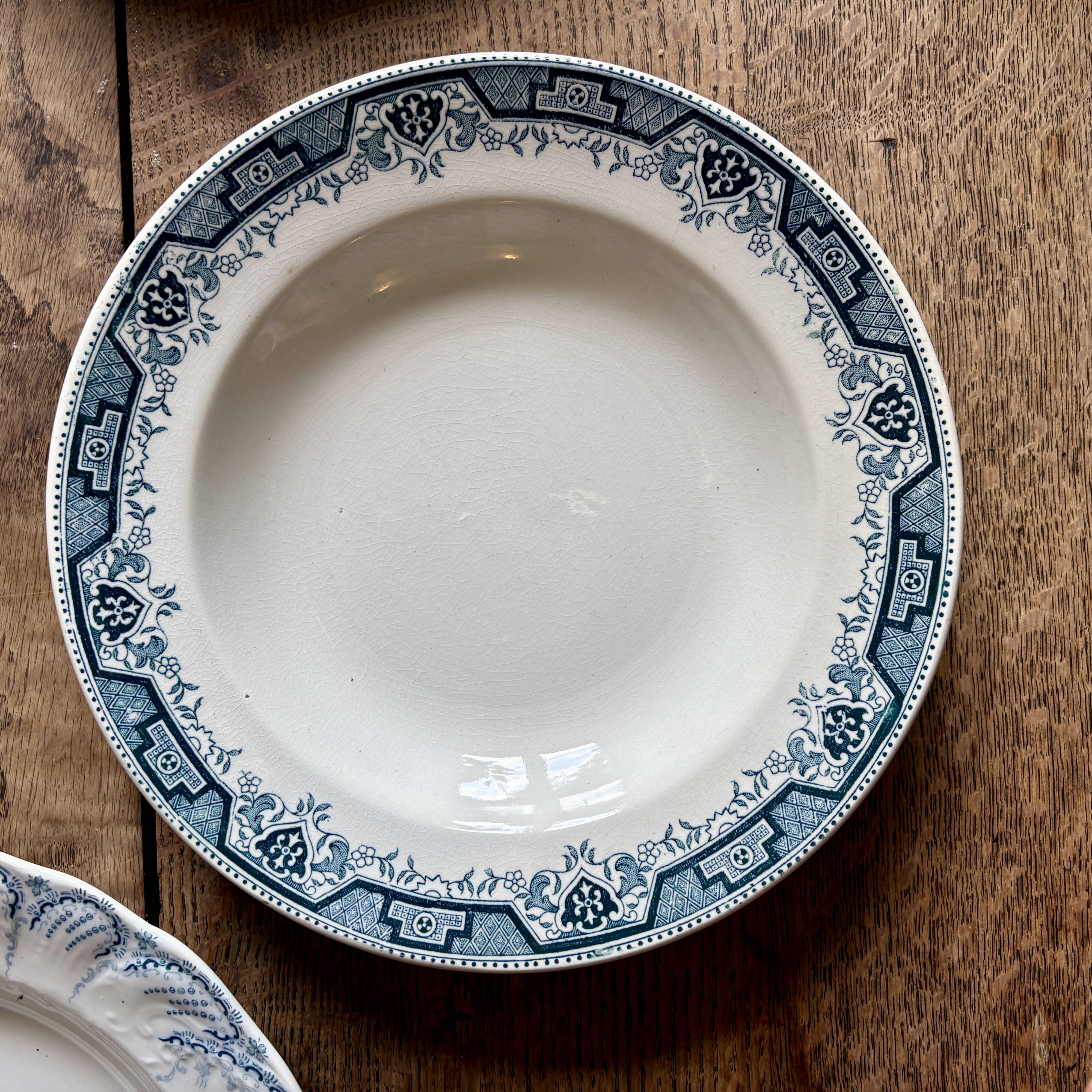 Set of 8 mismatched antique ironstone deep plates.
