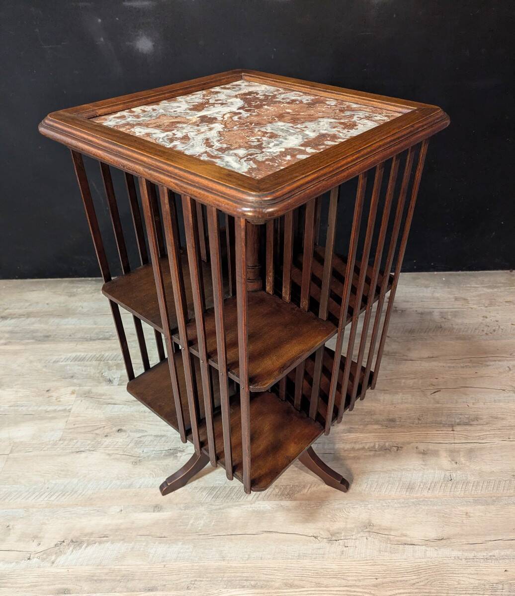 Rotating walnut library with a marble top.