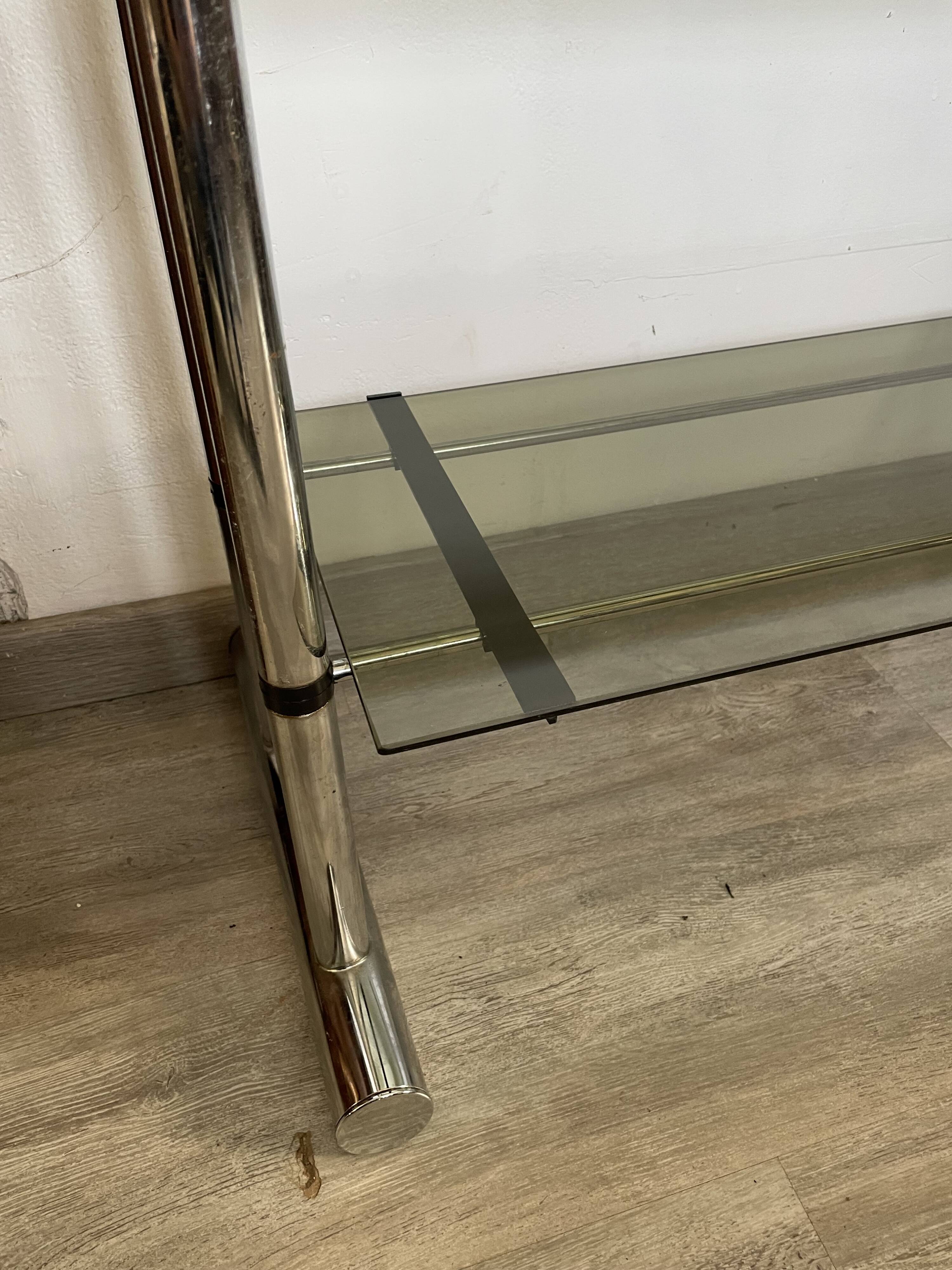 Chromed metal tubular shelf with smoked glass.