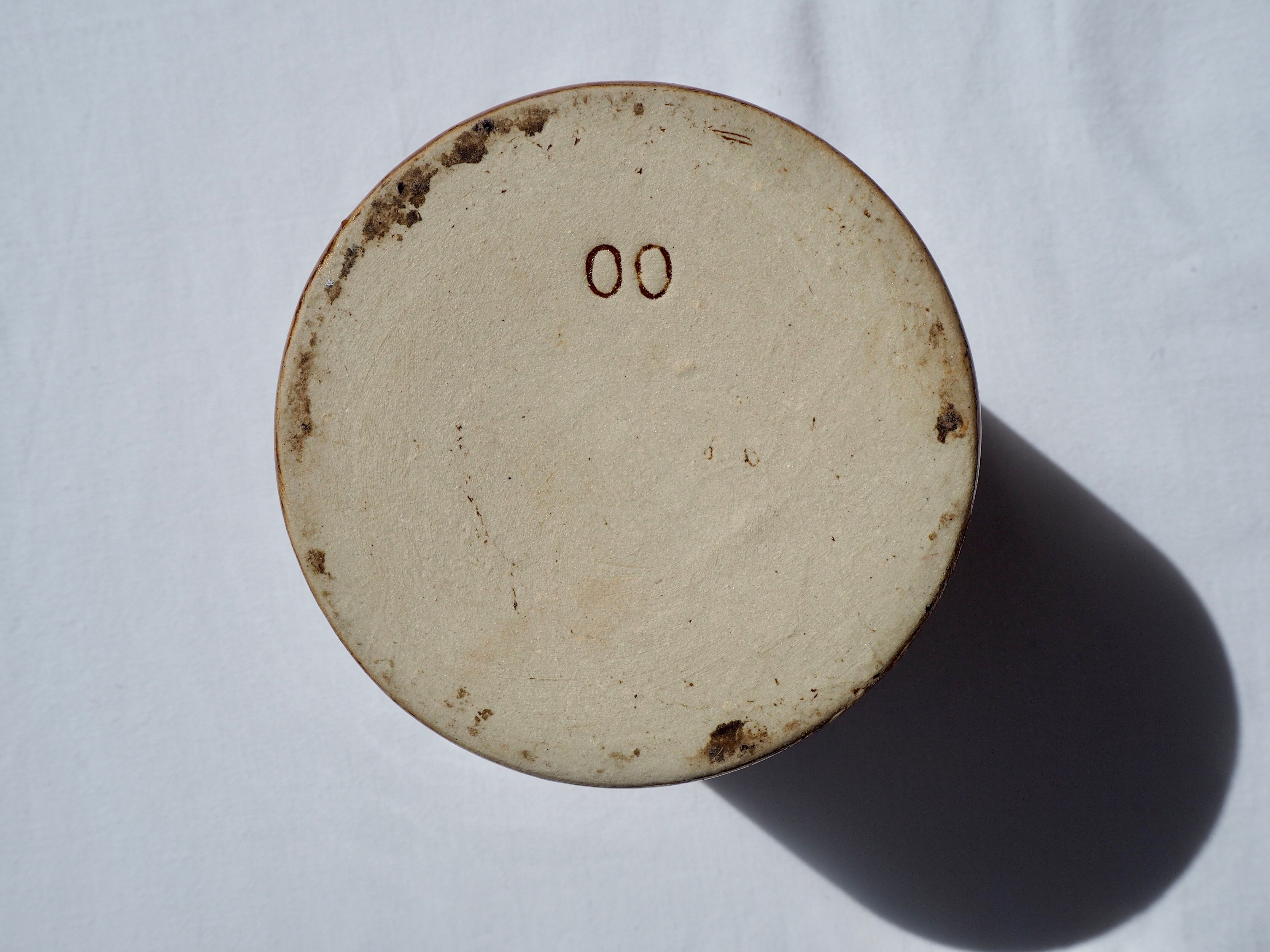 Trio of stoneware pots with lids