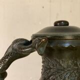 Bronze vase with snakes and a green patina, in the antique style.