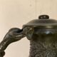 Bronze vase with snakes and a green patina, in the antique style.