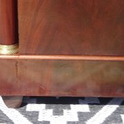 Flamed mahogany enfilade with sea green marble in Empire style.
