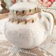 White porcelain sugar bowl decoration in relief and green and gold frieze