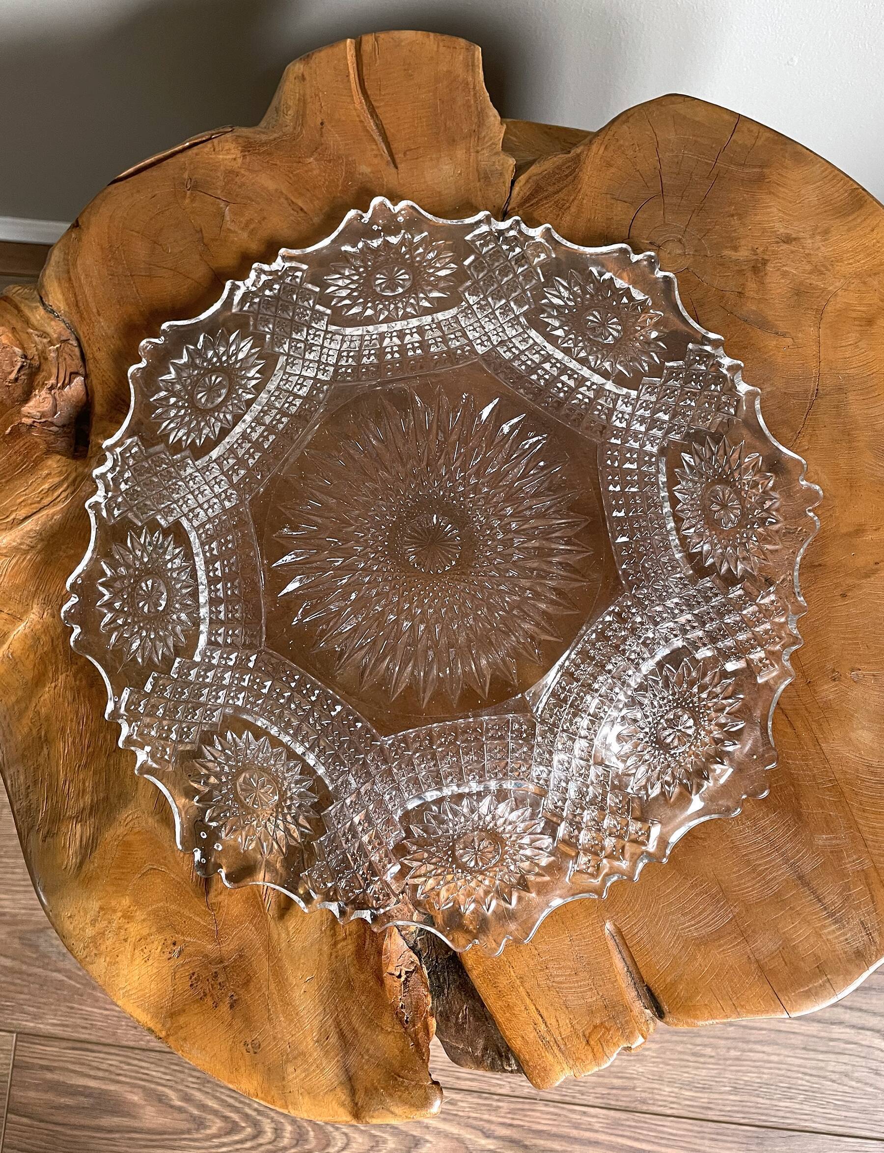 Vintage pressed glass plate with rosette design, octagonal rim, star pattern reminiscent of mandala