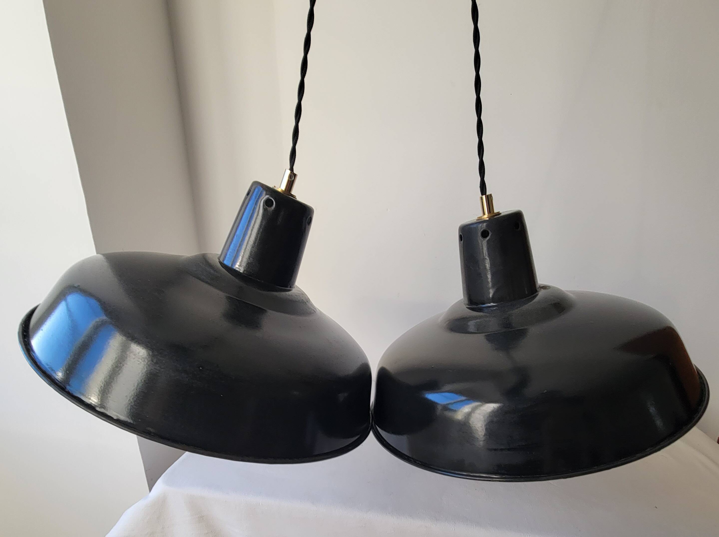 Duo of white and black enameled sheet metal pendants