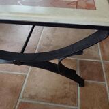 Rectangular coffee table with a stone top on wrought iron.