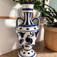 white amphora-style vase with hand-painted blue patterns