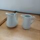 2 small white porcelain pitchers