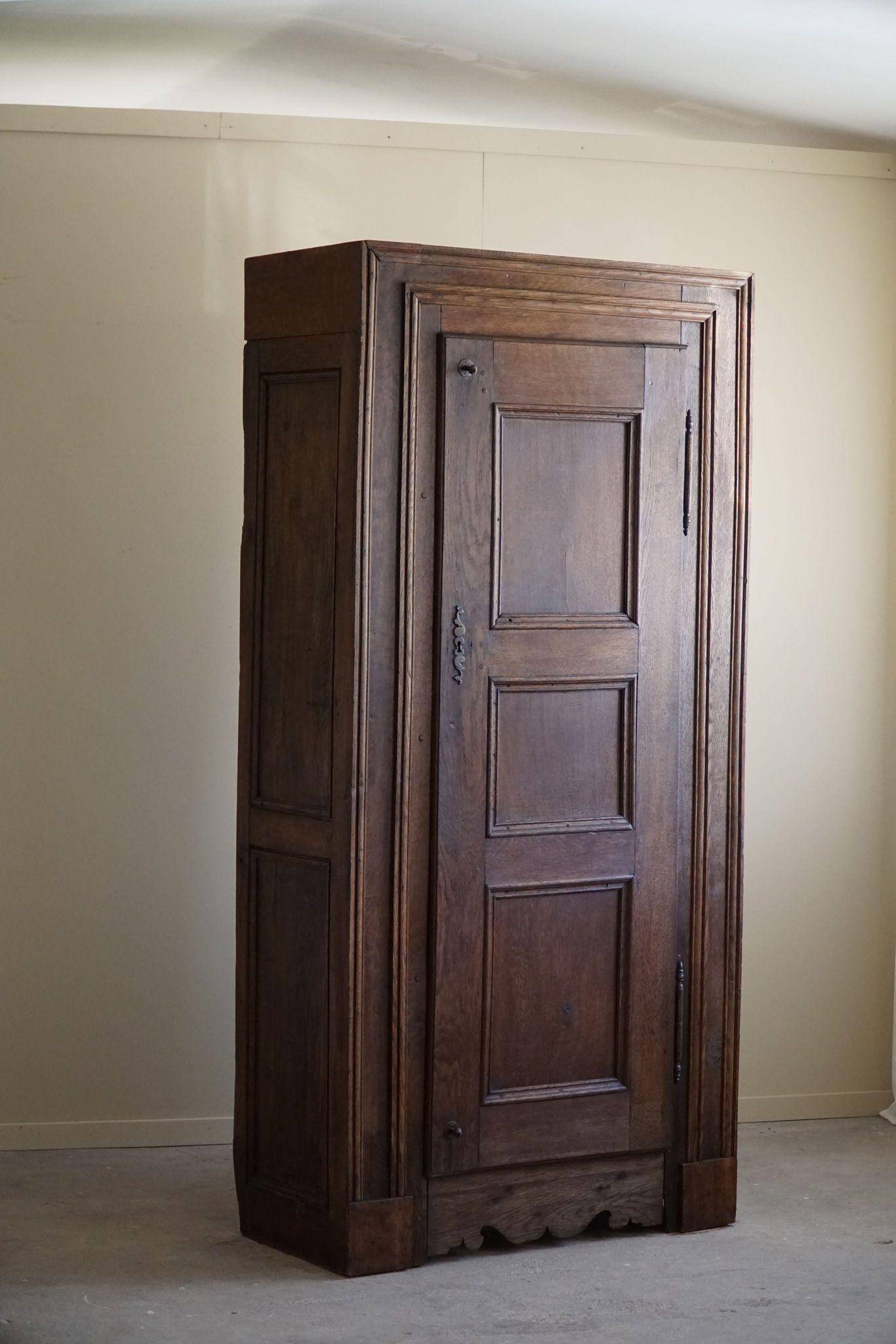 Tall antique oak wardrobe, made by a French cabinetmaker, late 19th century.
