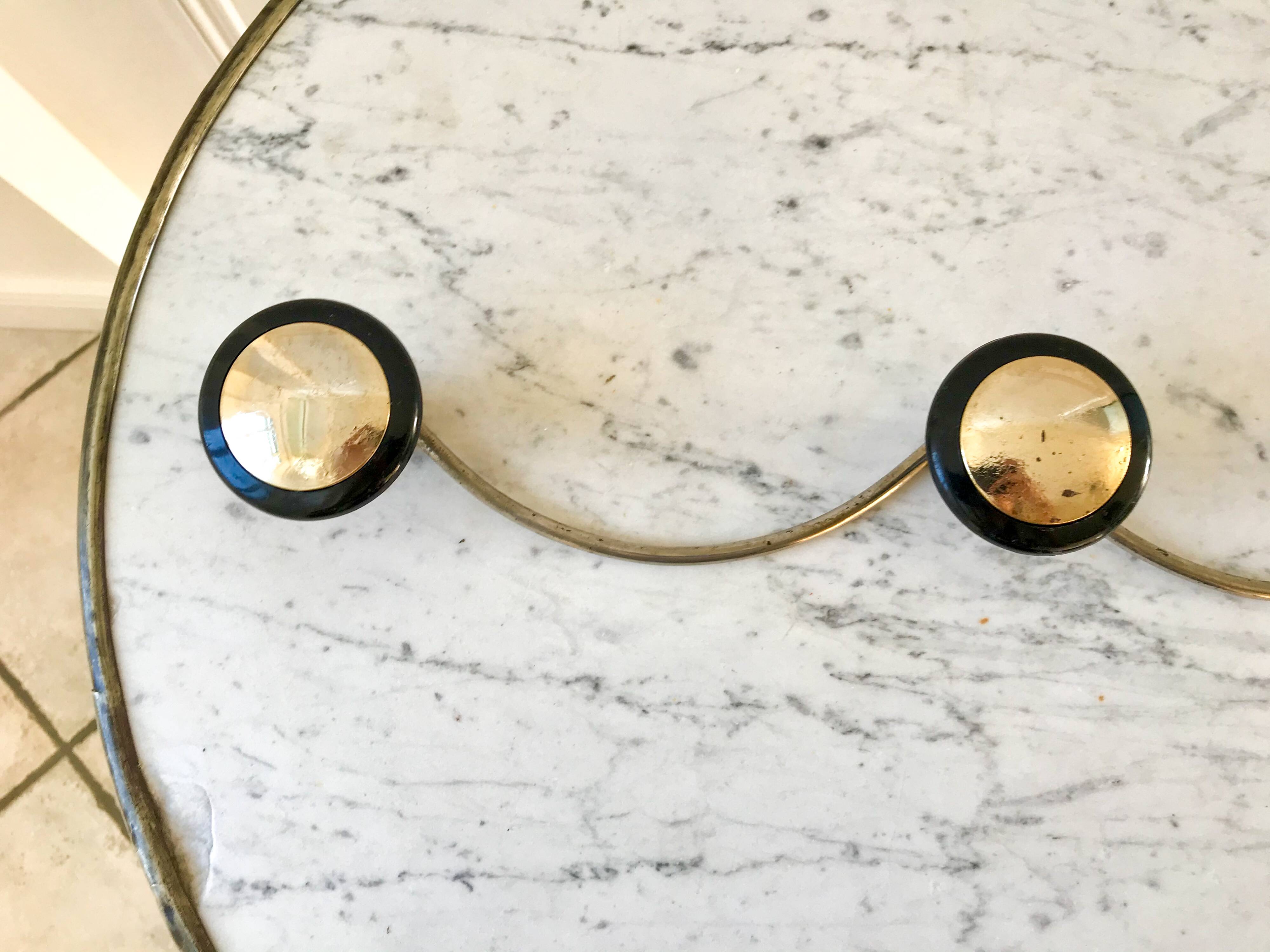 silver and black metal coat hook from the 70s