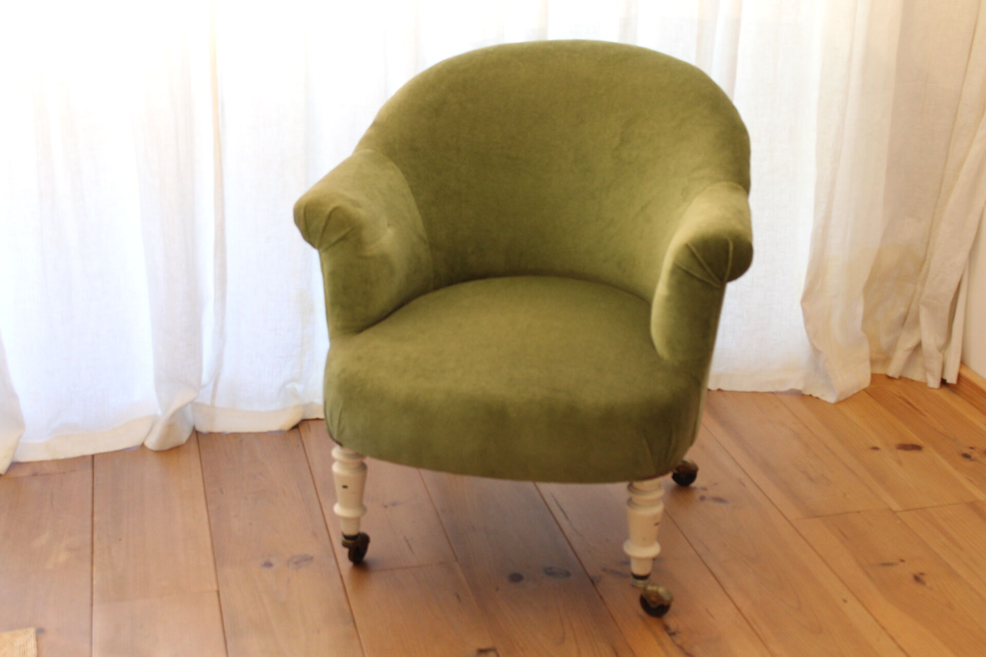 Toad in almond green velvet armchair on castors