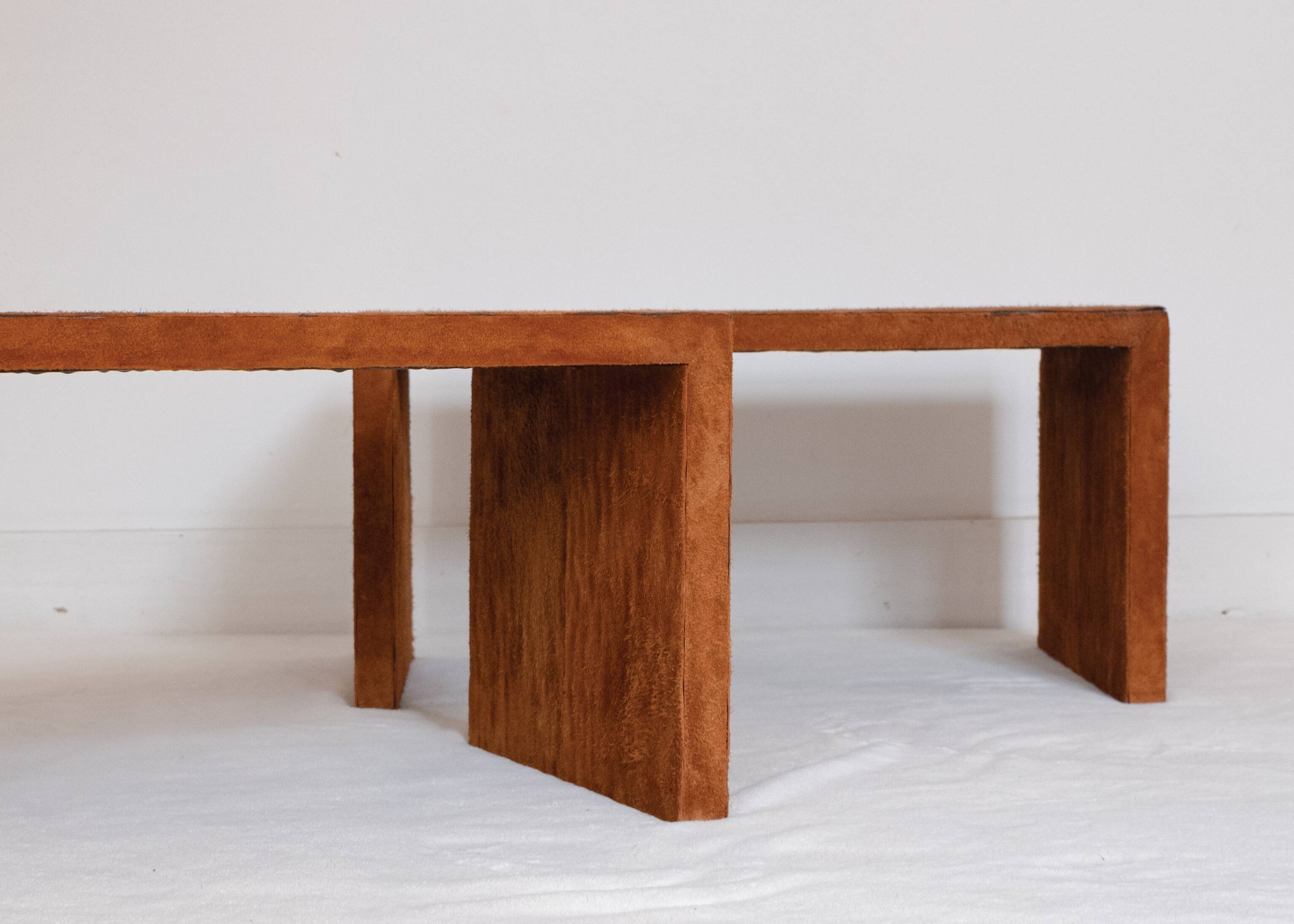 Pair of cognac suede side tables in the style of Jean Michel Frank.