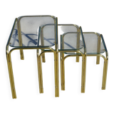 Nested tubular tables in gold metal.