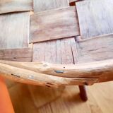 Old bamboo/rattan table with woven palm leaves.