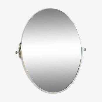 Oval mirror in patinated gold metal