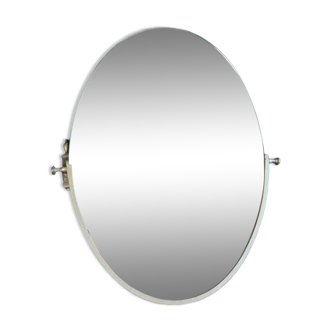 Oval mirror in patinated gold metal