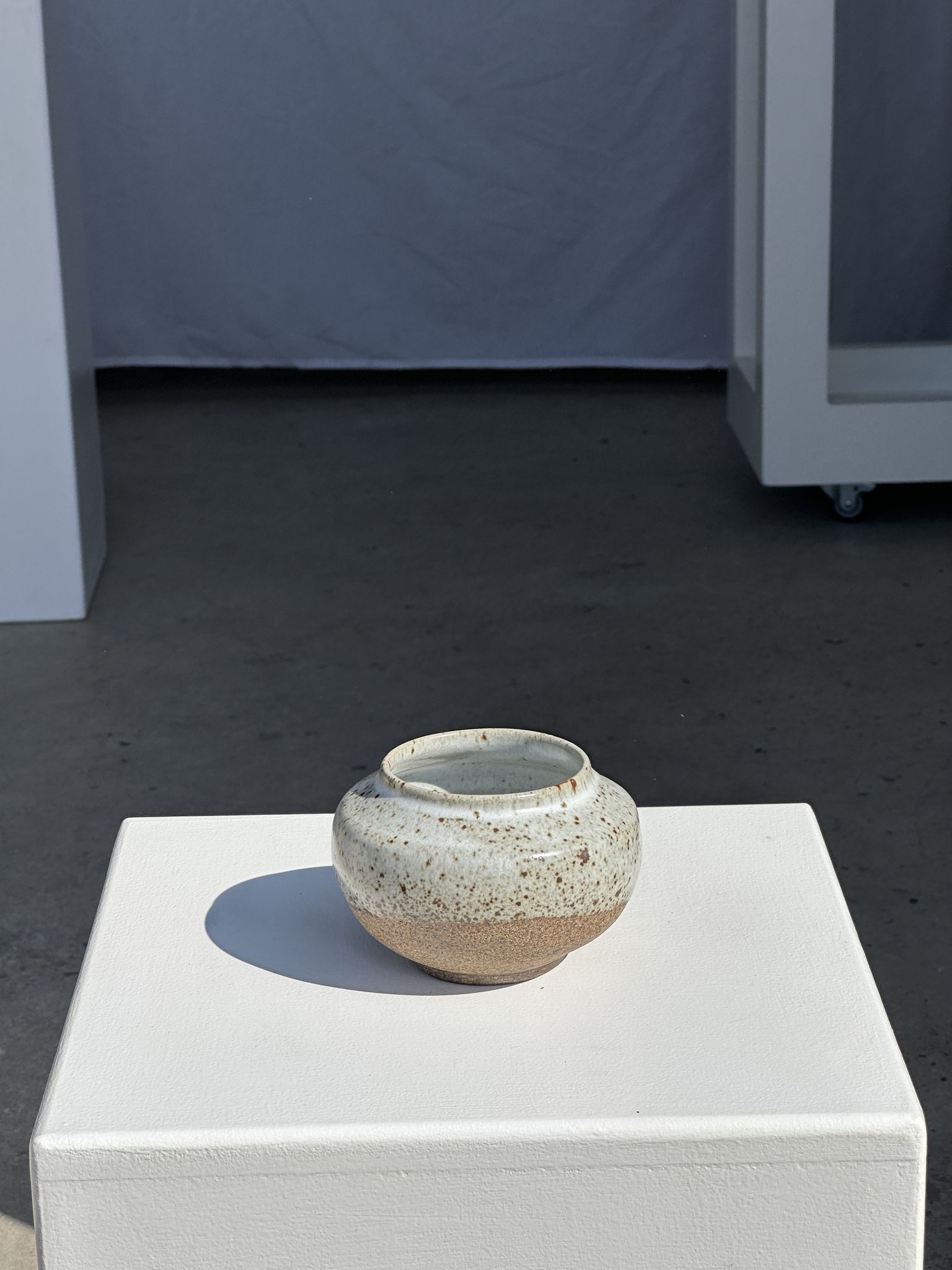 Small white ball vase tight neck in glazed speckled ceramic