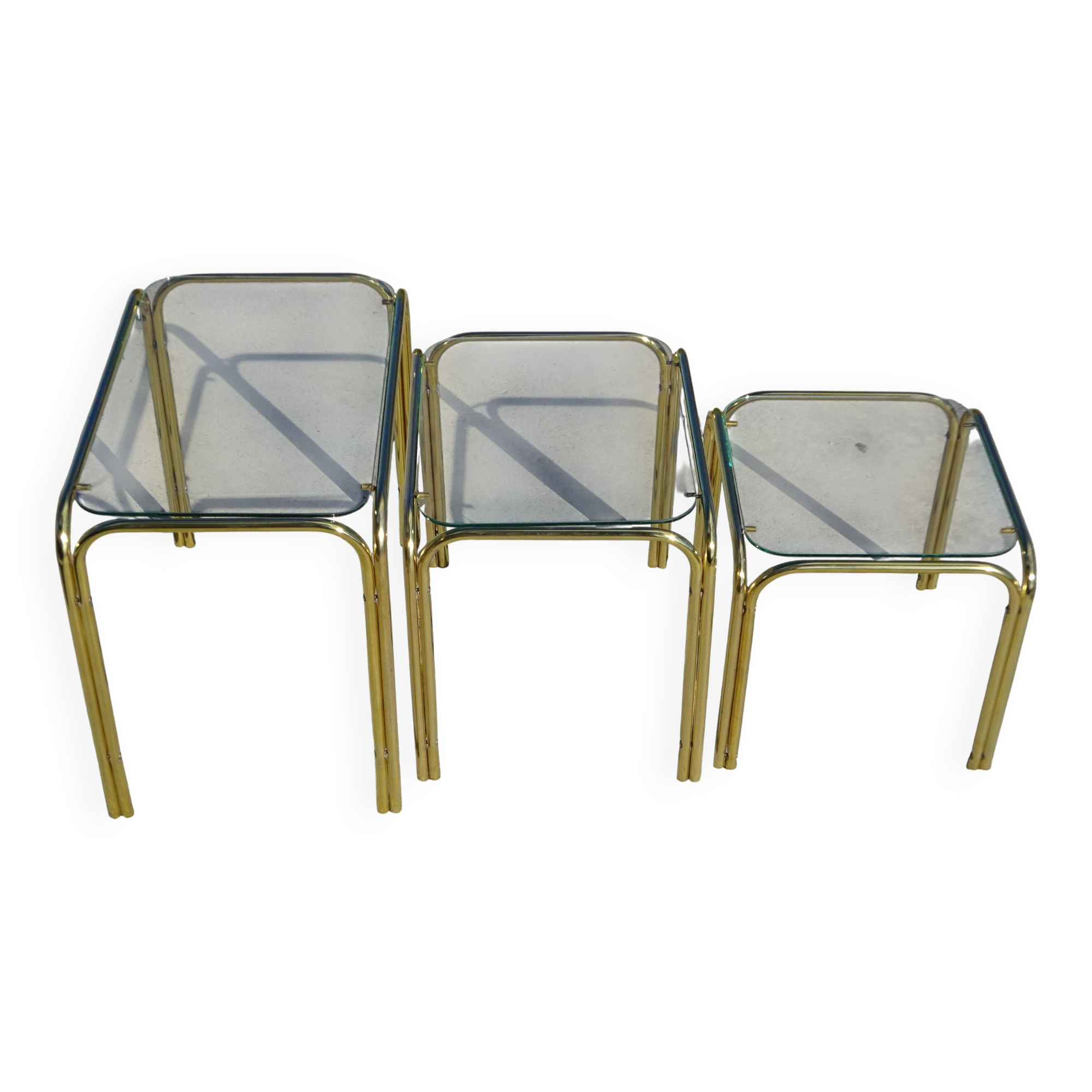 Nesting tables in gold-tone metal and glass