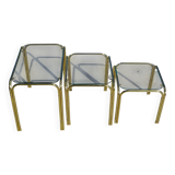 Nesting tables in gold-tone metal and glass