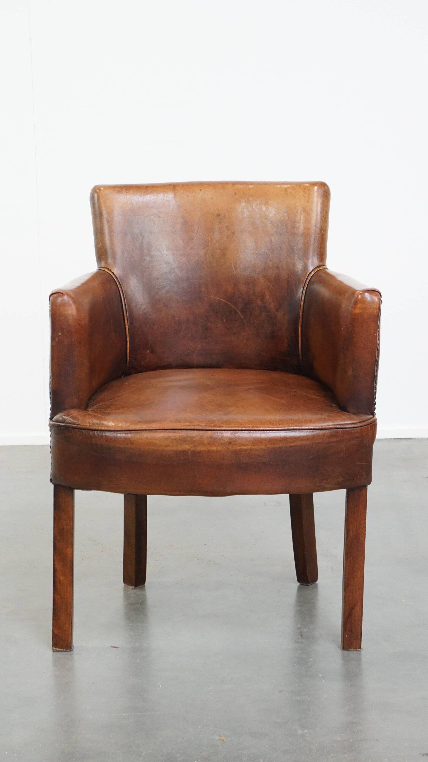 Amazing cognac-coloured sheepskin dining/side chair with armrests