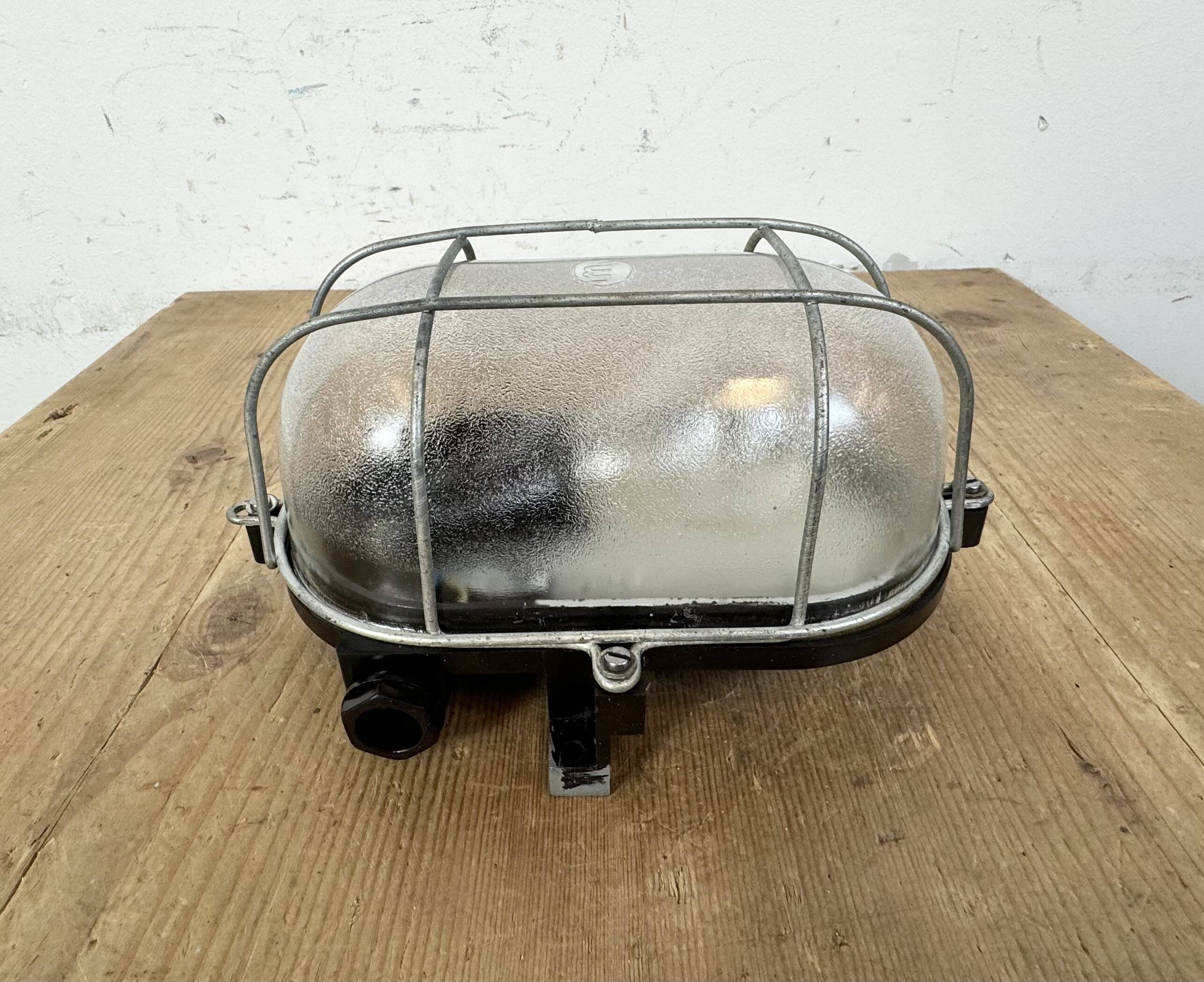 Industrial brown bakelite wall light with frosted glass, 1960s