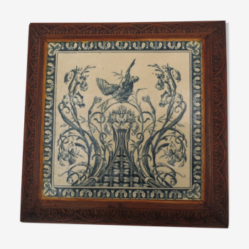flat underside/faience tile decorated with gien on carved wood frame