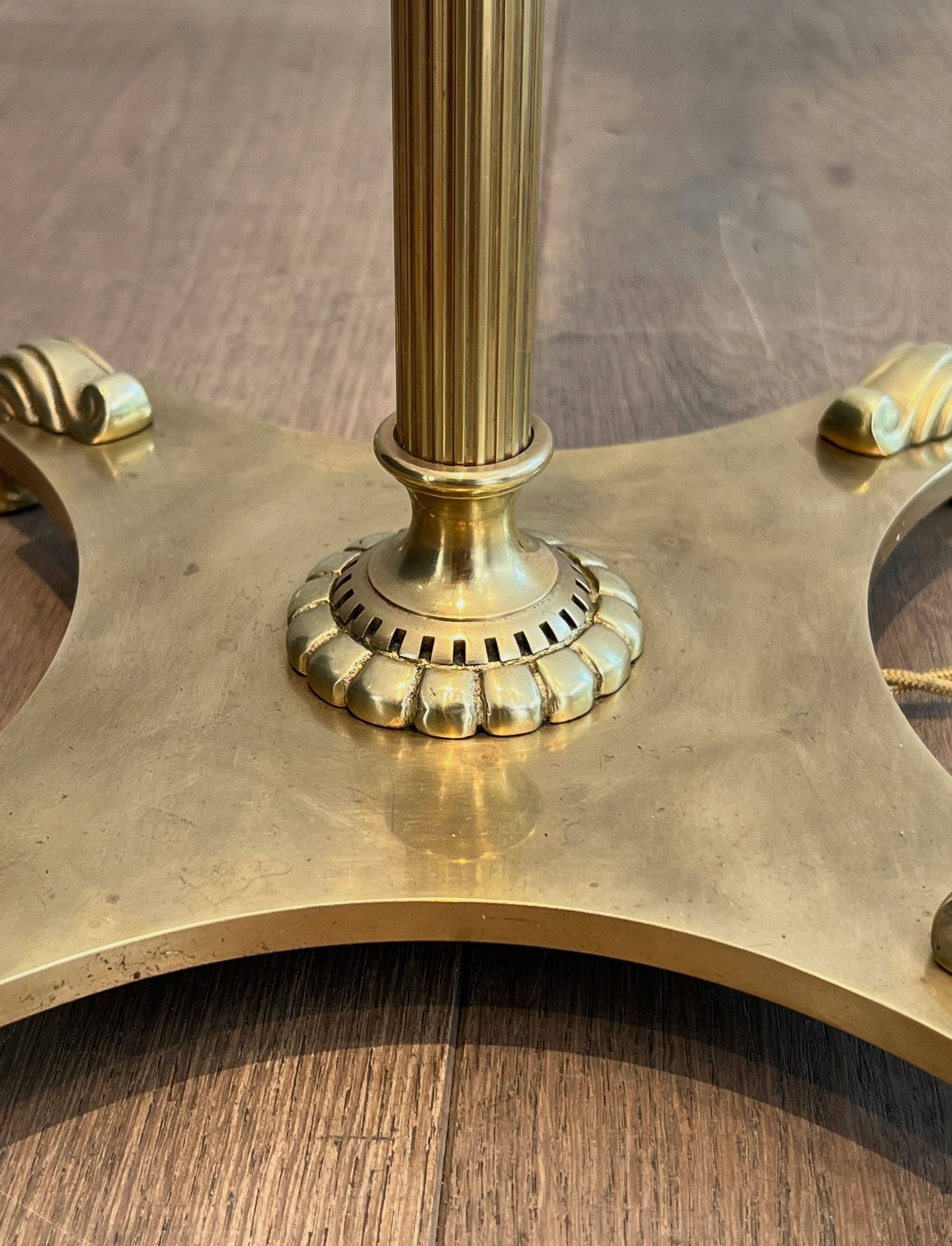 Neoclassical brass floor lamp with claw feet from Maison Jansen.