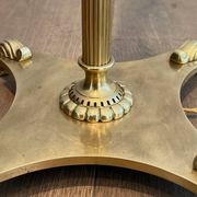 Neoclassical brass floor lamp with claw feet from Maison Jansen.