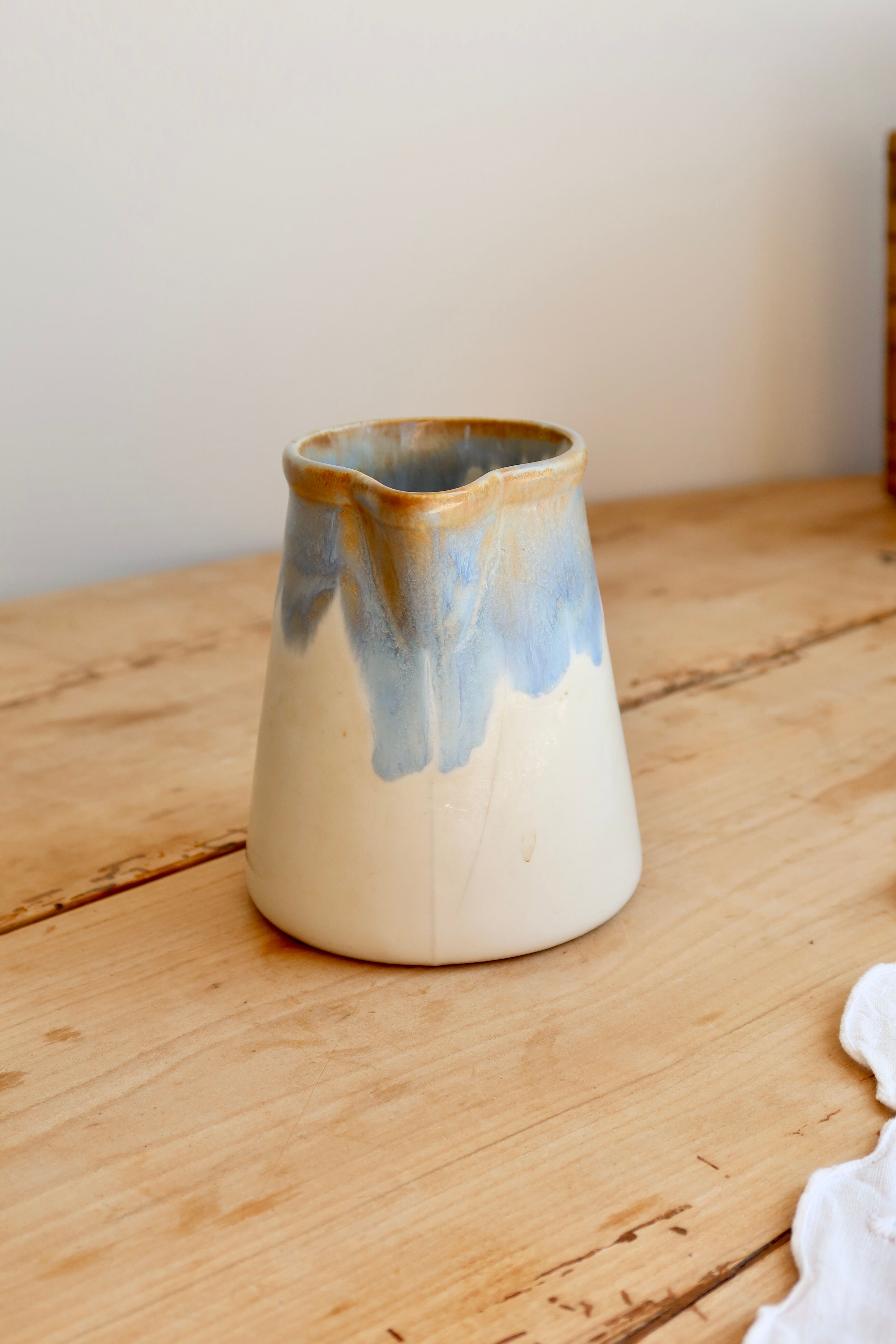 Vintage ceramic milk jug with a blue and taupe gradient glaze.