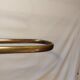 Old golden brass towel rack on baroque style foot