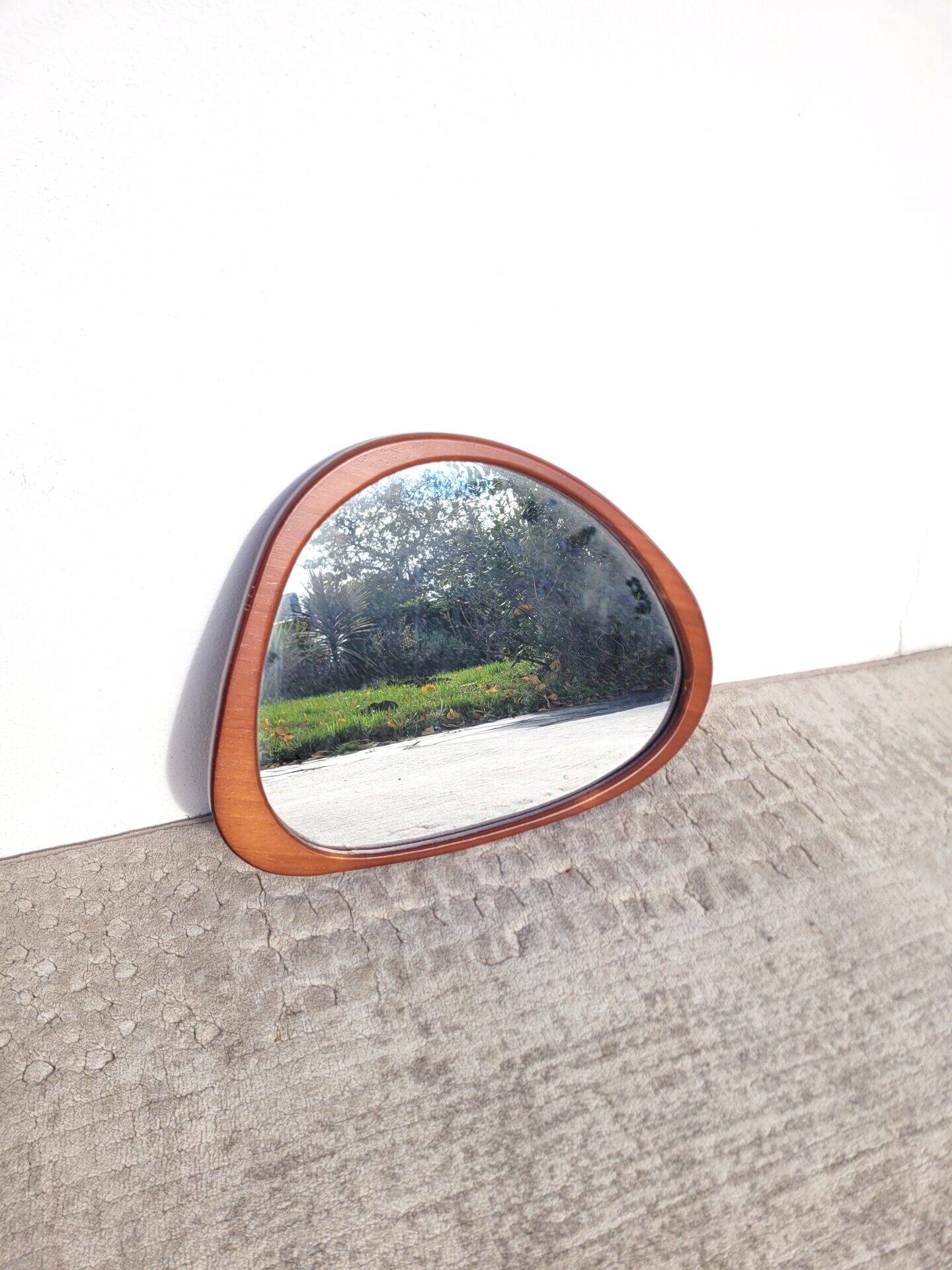 Contemporary oval mirror in teak finish