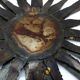 Large brutalist sun mirror in patinated metal with gold accents, 1970.