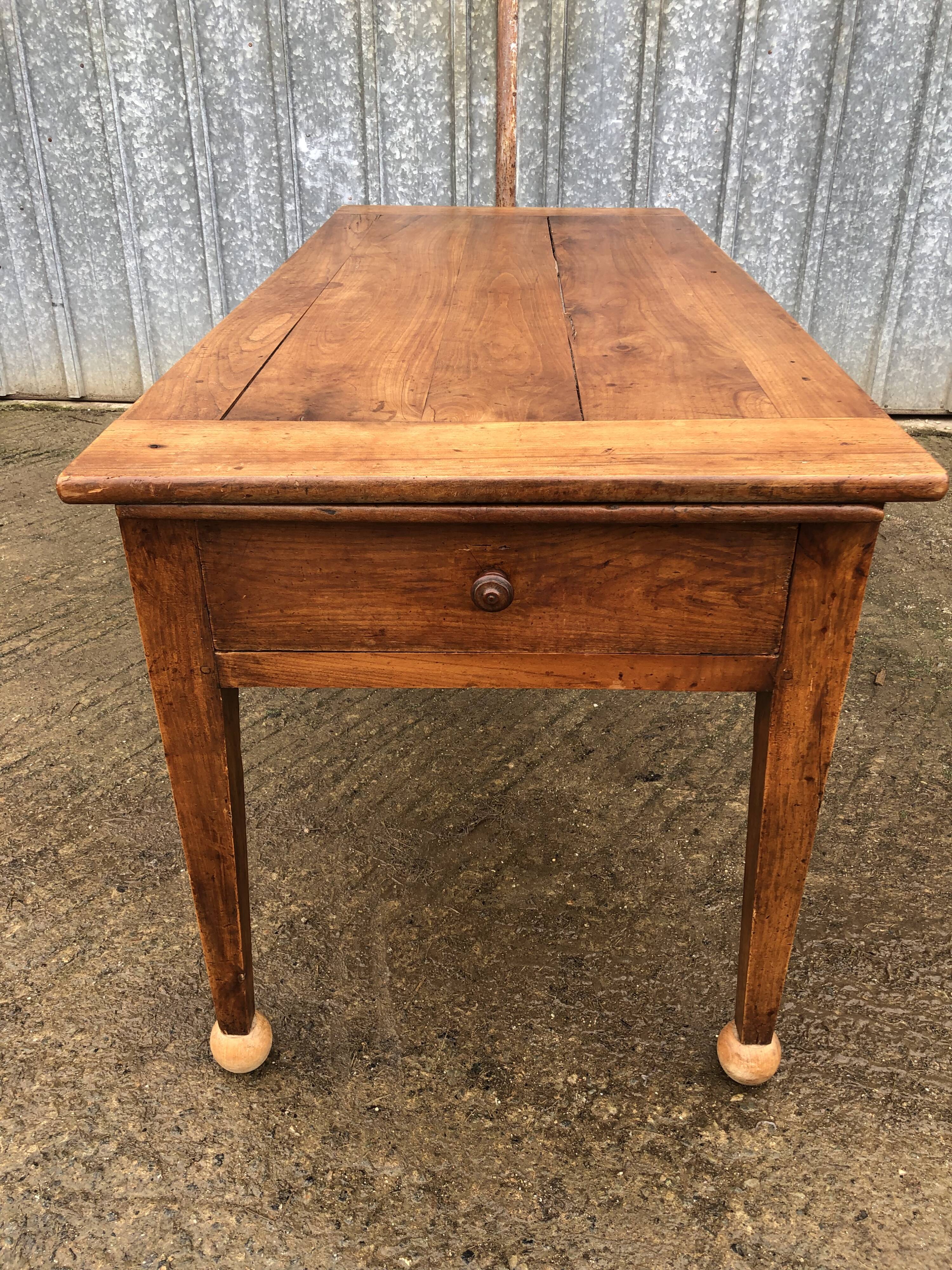 Antique solid cherry farmhouse table with 2 end drawers and 1 pull-out.
