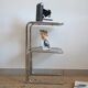 Glass-topped side table with tubular metal.