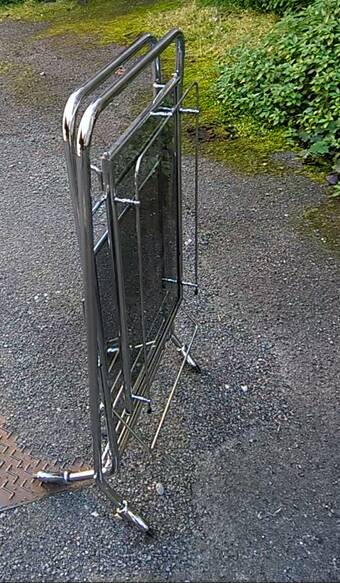 Foldable stainless steel serving trolley with smoked glass tops