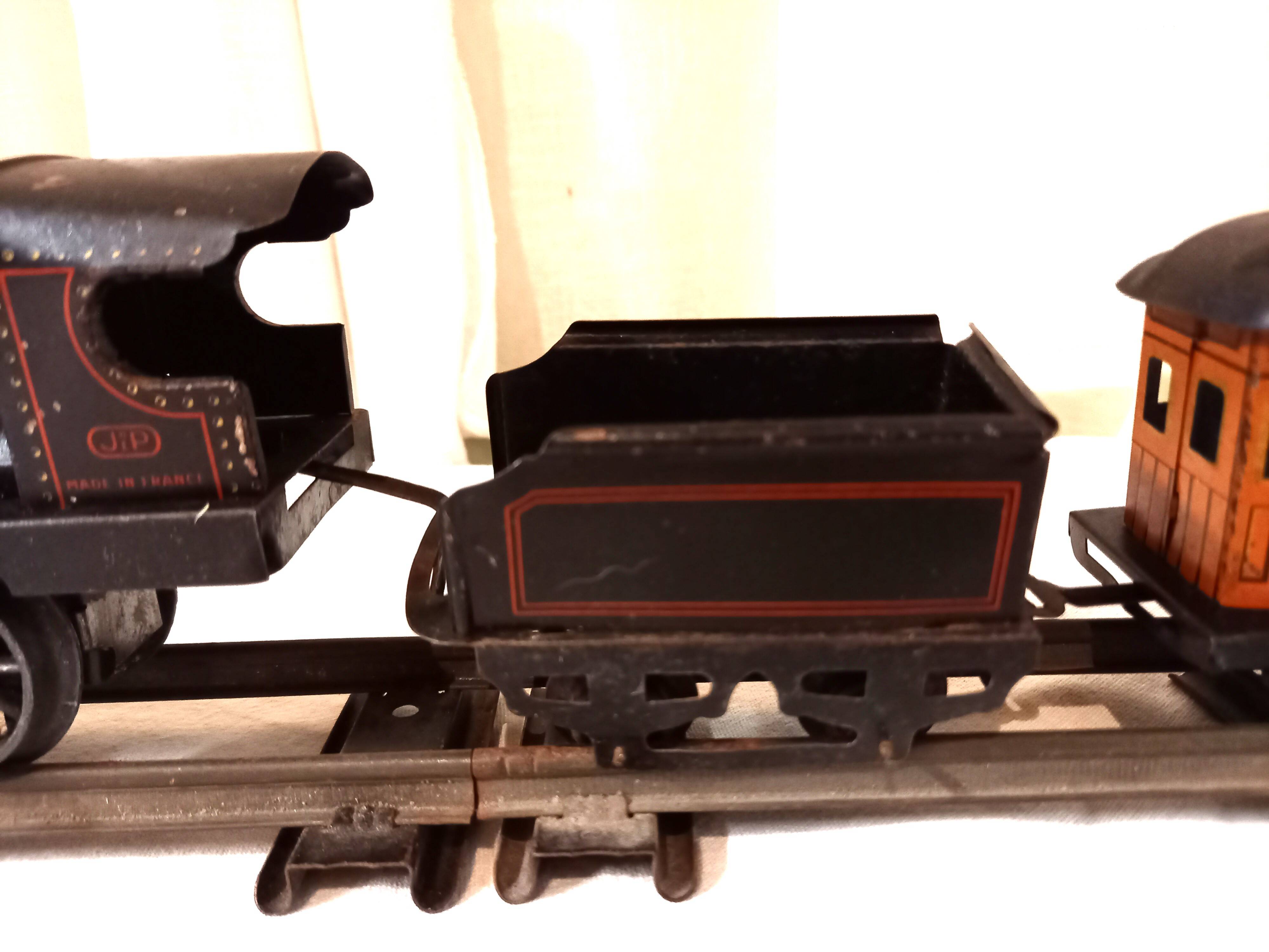 Small JEP mechanical train, including locomotive, tender, sleeping car, rail, 1930s