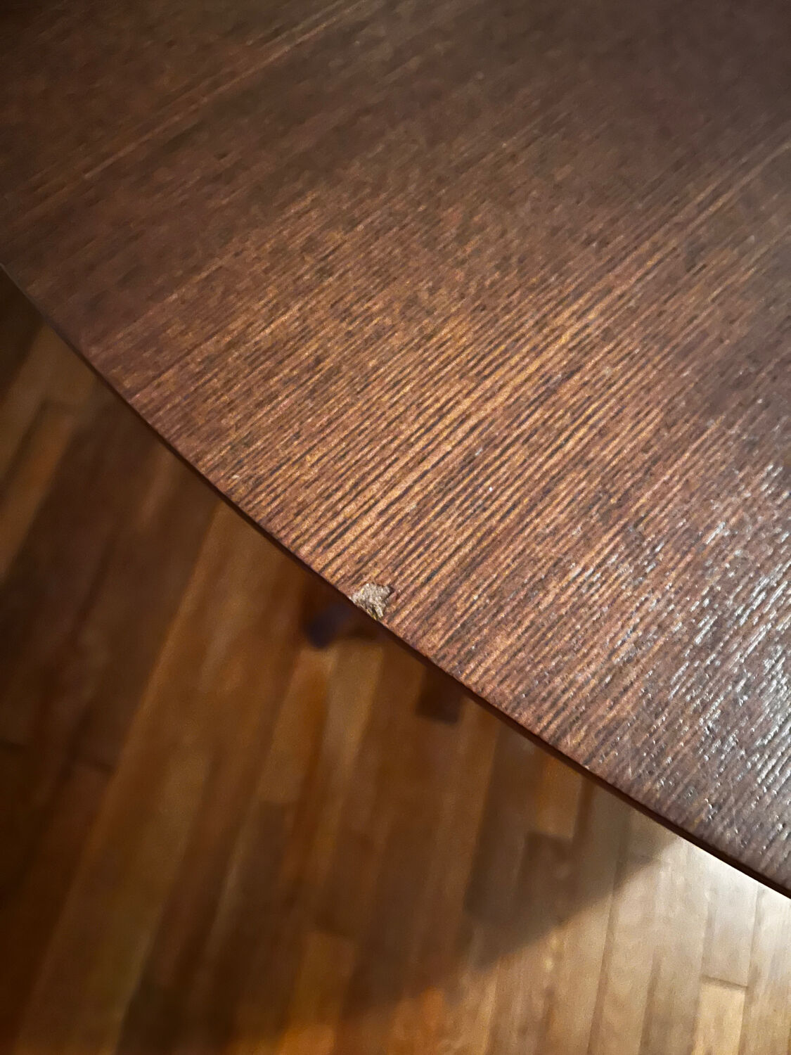 Round table made of solid wood with a walnut finish top.