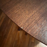 Round table made of solid wood with a walnut finish top.