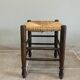 Wooden stool with a straw seat