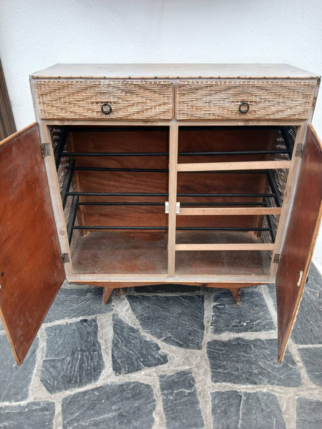 Vintage woven rattan furniture with tapered legs.