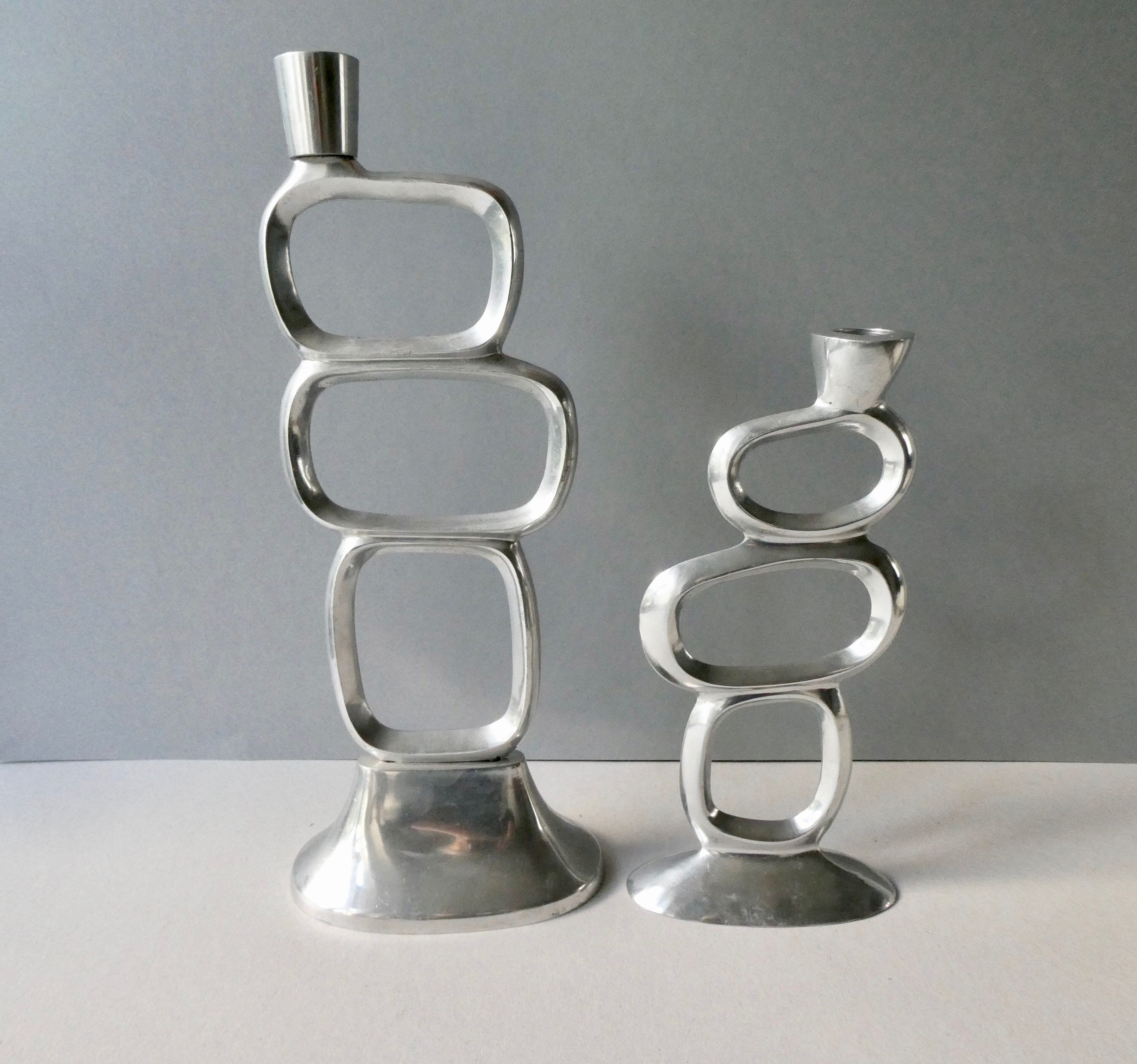 Pair of cast aluminum candle holders, design