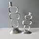 Pair of cast aluminum candle holders, design