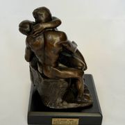 The bronze sculpture The Kiss, a reproduction of Rodin's statue, French sculpture.