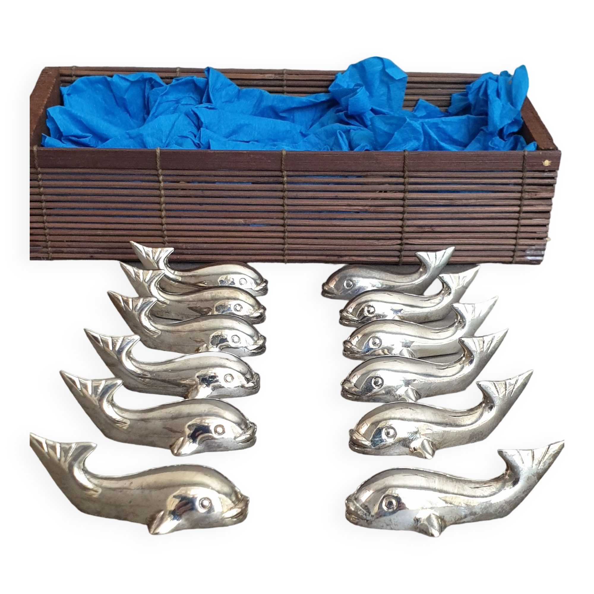 Lot 12 knife holders in the shape of a stylized whale or fish