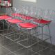 Tabouret de bar Harry Bertoia Knoll chromé galette rouge