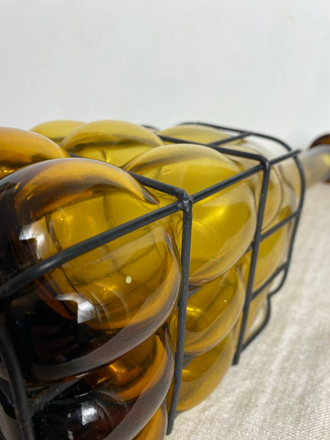 Glass carafe encased in wrought iron